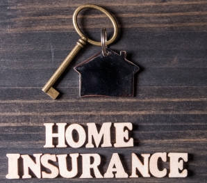 Image of key fob shaped like a house attached to key. Words "Home Insurance" spelled with little letter bricks below.
